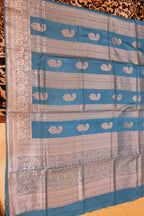 Saree with blue and beige pattern on a textured surface