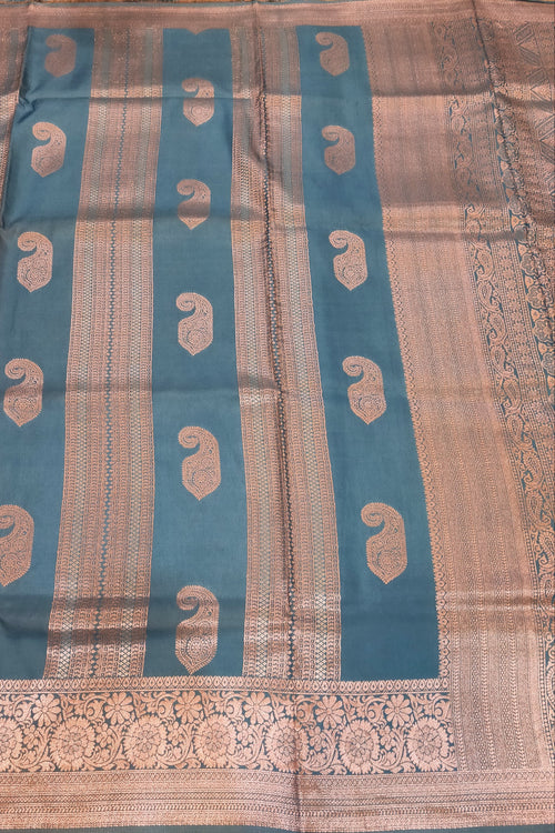 Traditional fabric with blue and beige patterns on a wooden surface