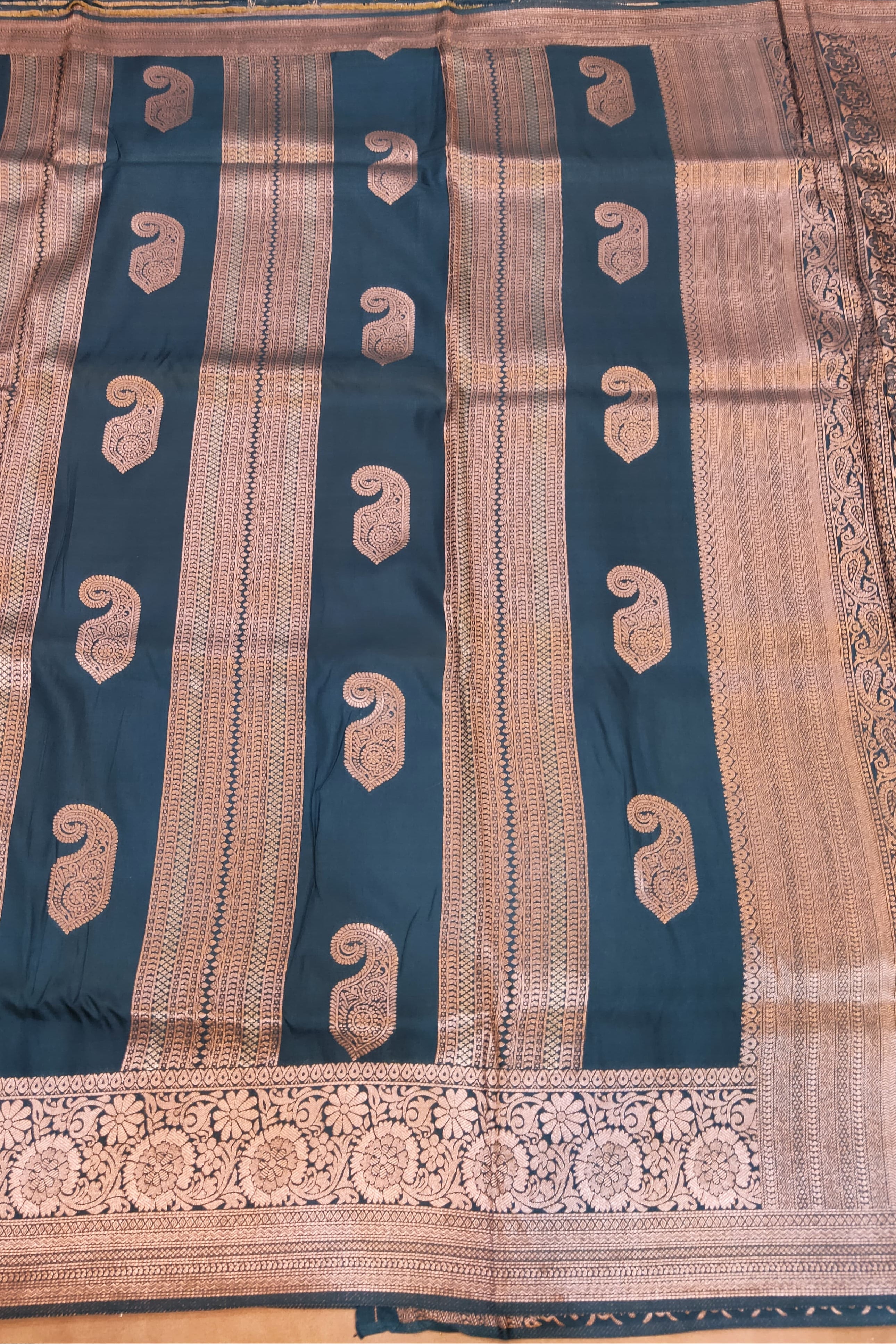 Traditional fabric with blue and beige patterns on a wooden background