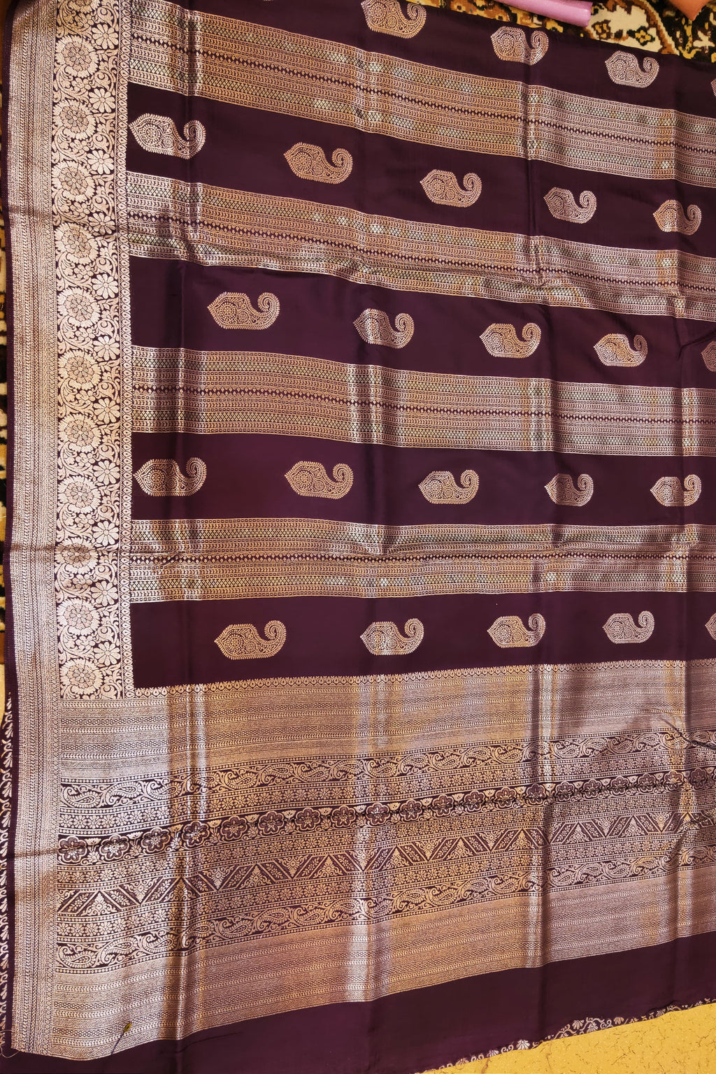 Brown and gold patterned fabric with decorative border