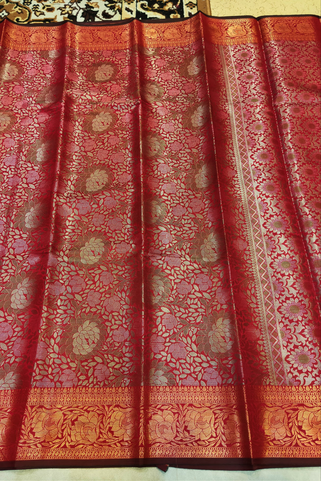 Red and gold patterned fabric with intricate designs