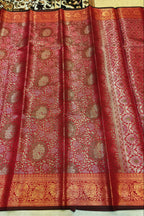 Red and gold patterned fabric with intricate designs
