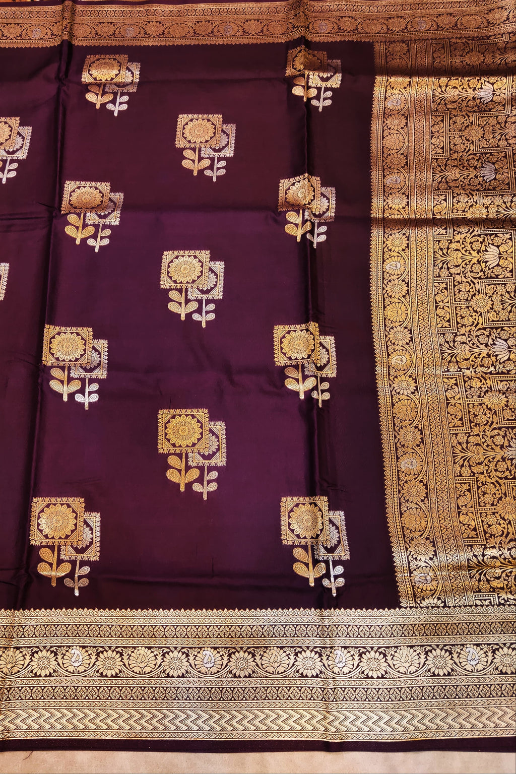 Purple saree with gold floral patterns and border