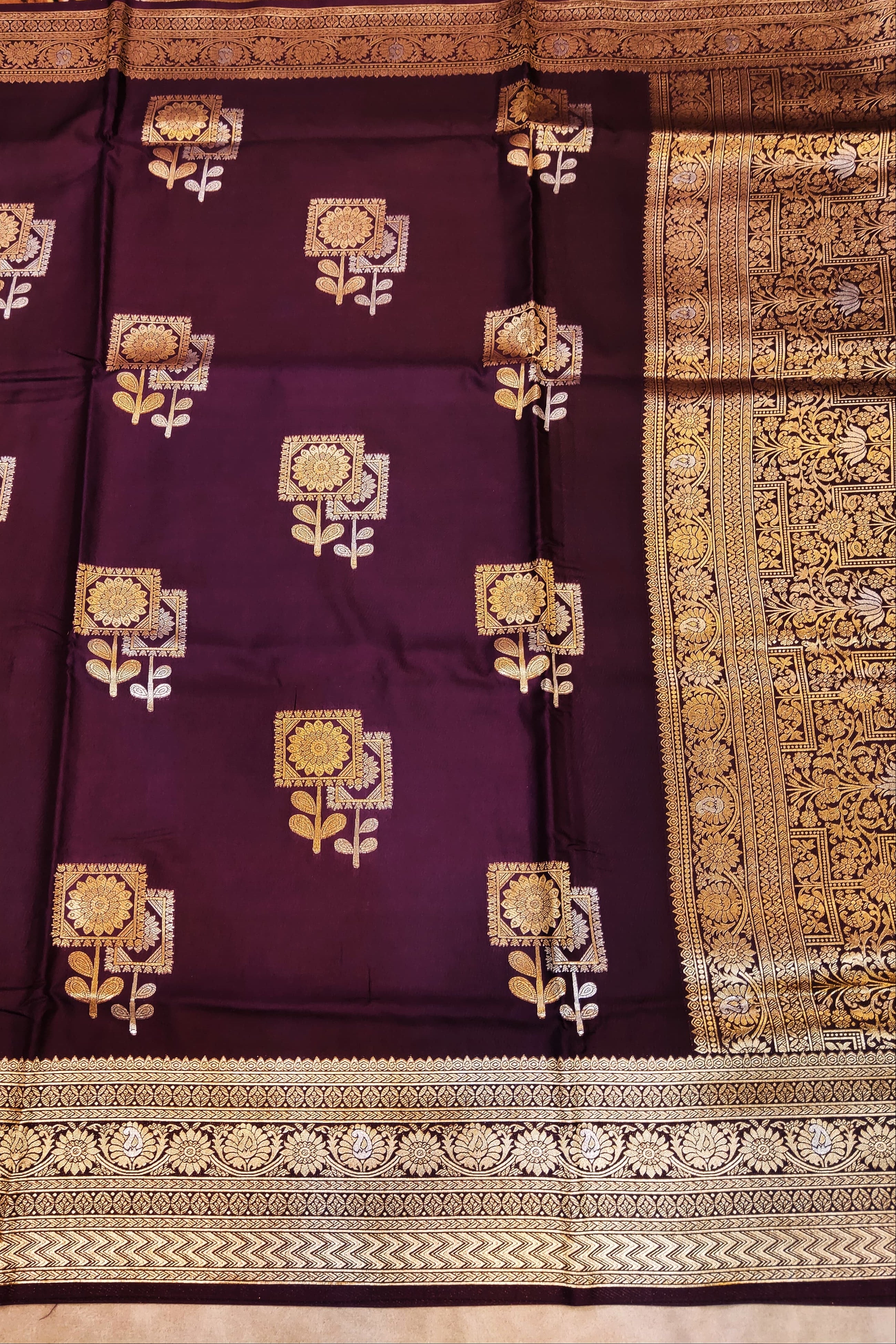 Purple saree with gold floral patterns and border