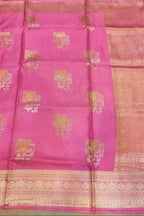 Pink saree with gold patterns on a plain background