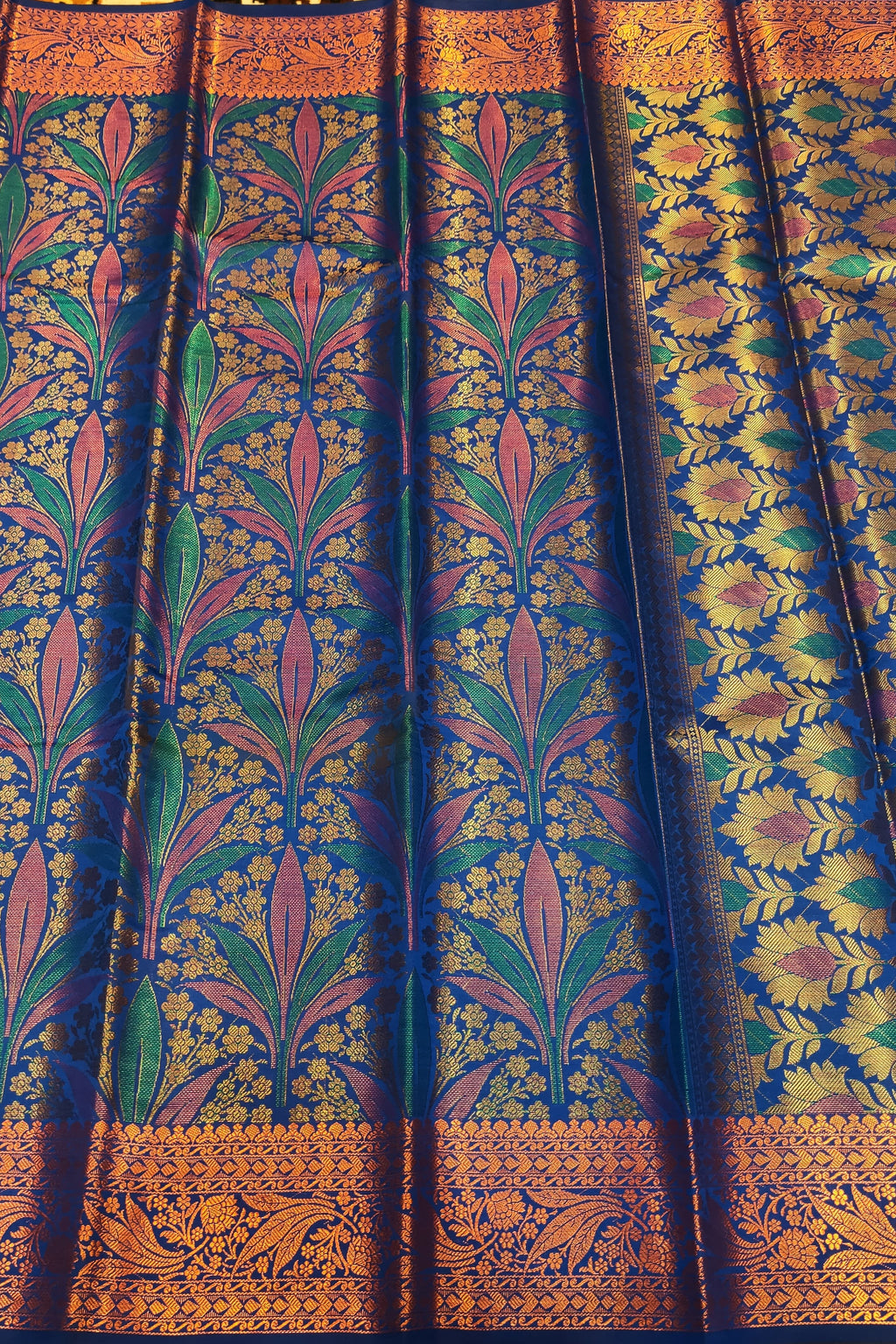 Traditional patterned fabric with intricate designs on a yellow background