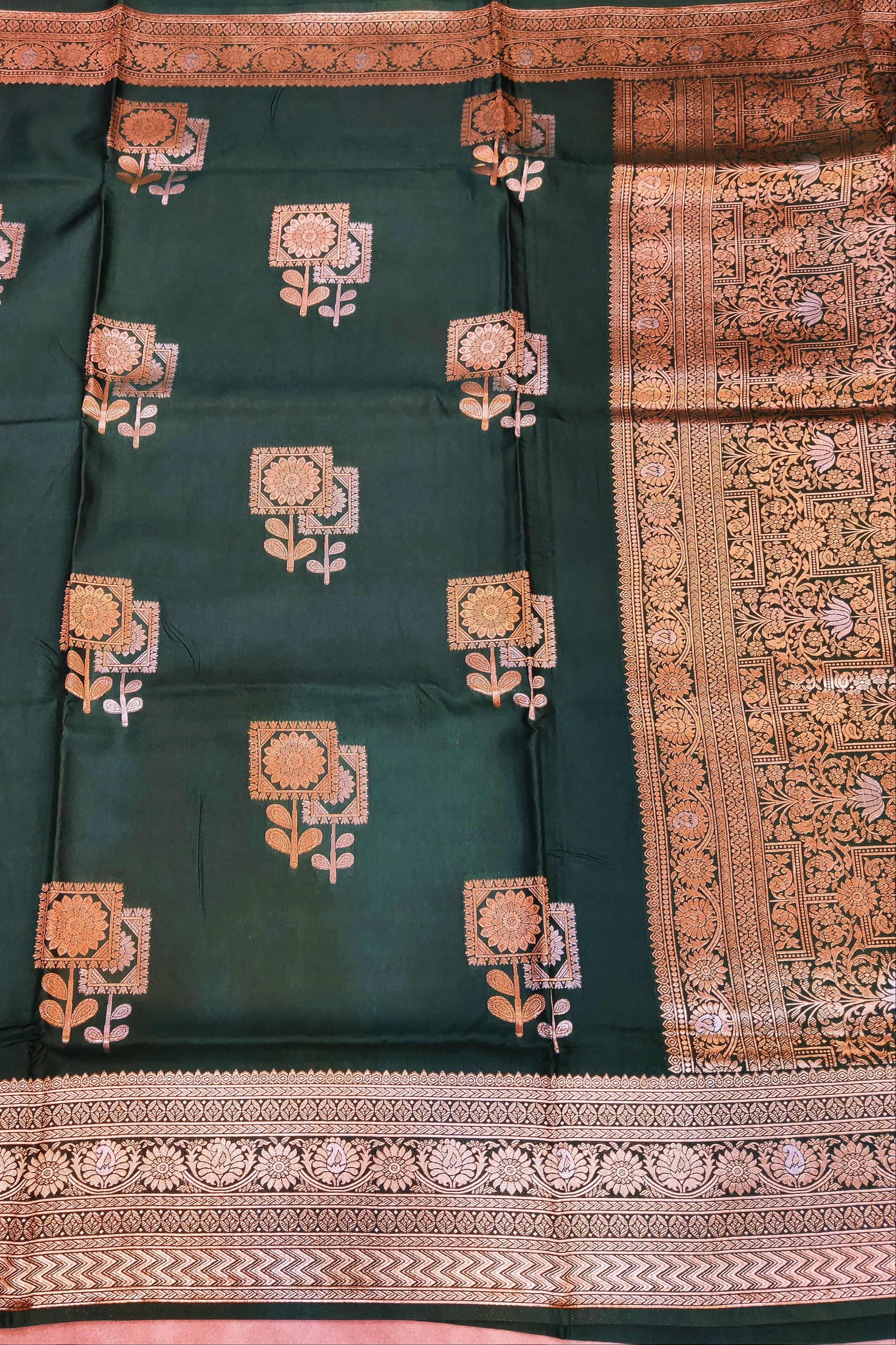 Green saree with floral patterns and gold border