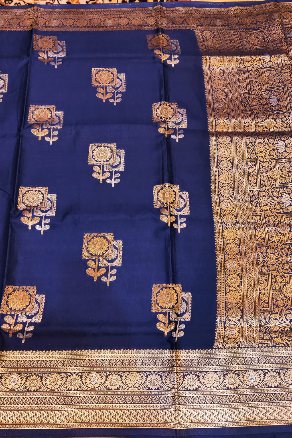 Blue fabric with gold and white floral patterns