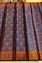 Patterned fabric with blue and brown design on a beige background