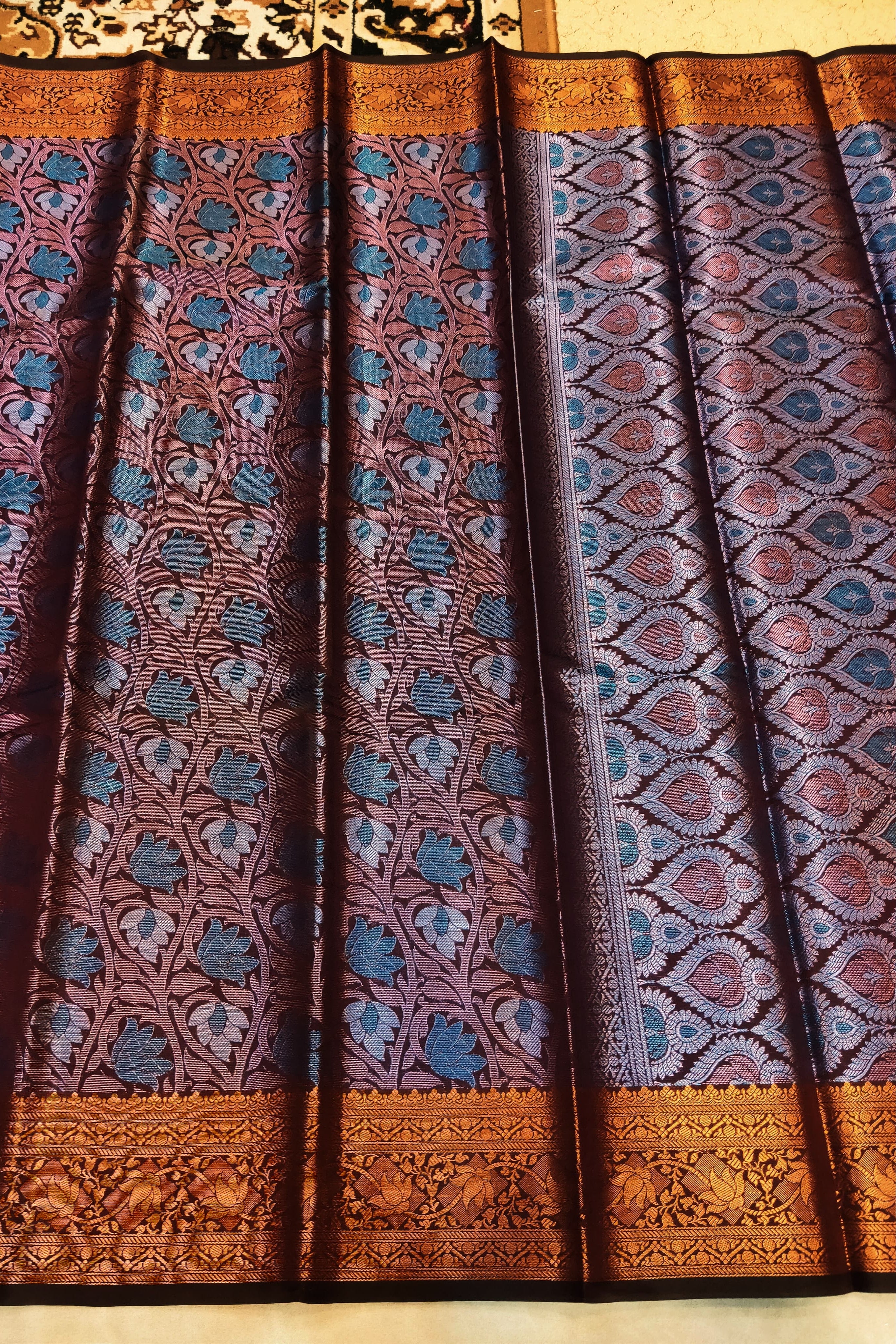 Patterned fabric with blue and brown design on a beige background