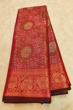 Red and gold patterned fabric on a beige background