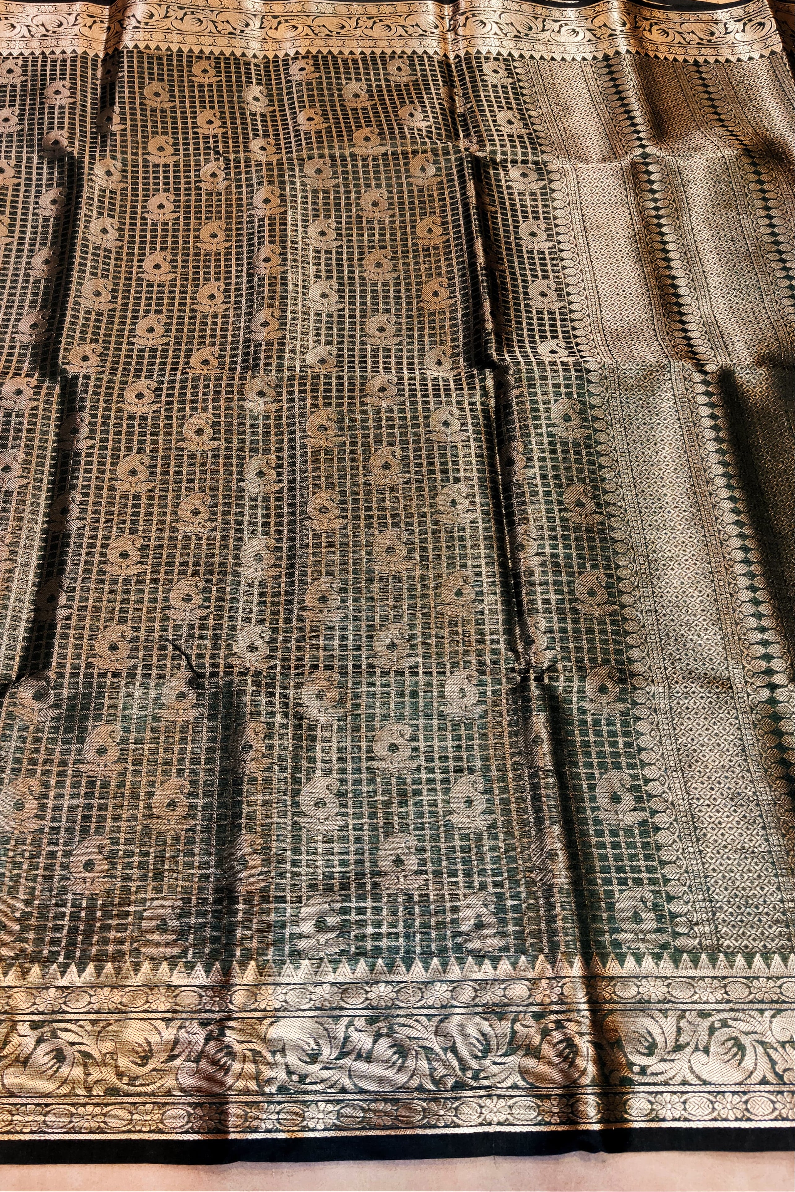 Black and white patterned fabric with intricate designs on a wooden surface