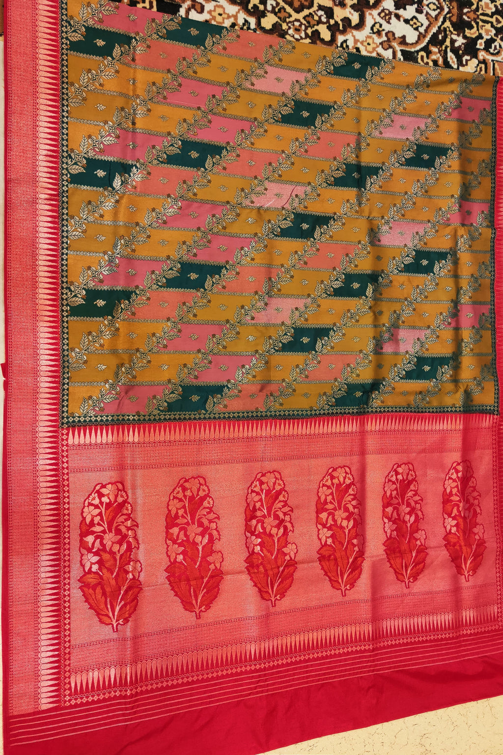Saree with a geometric pattern and floral border on a plain background
