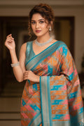 Woman wearing a colorful saree with a blurred indoor background
