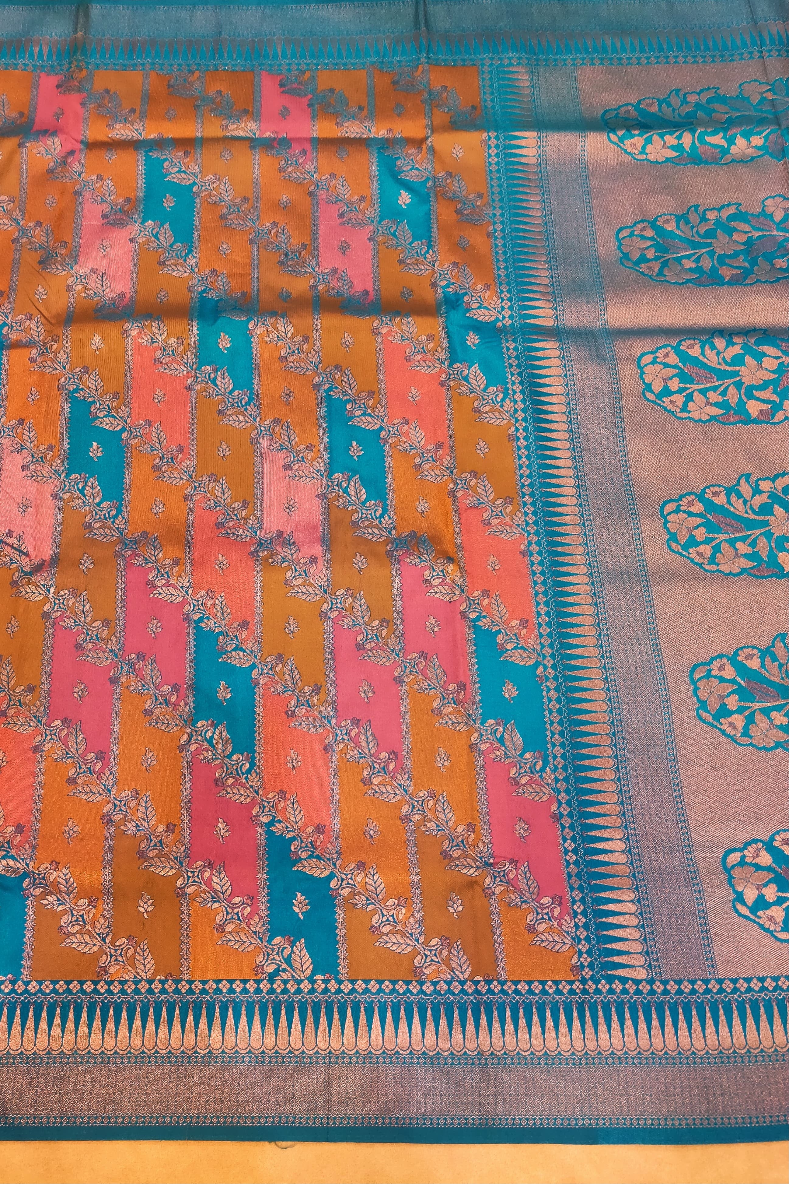 Colorful traditional fabric with intricate patterns on a wooden surface