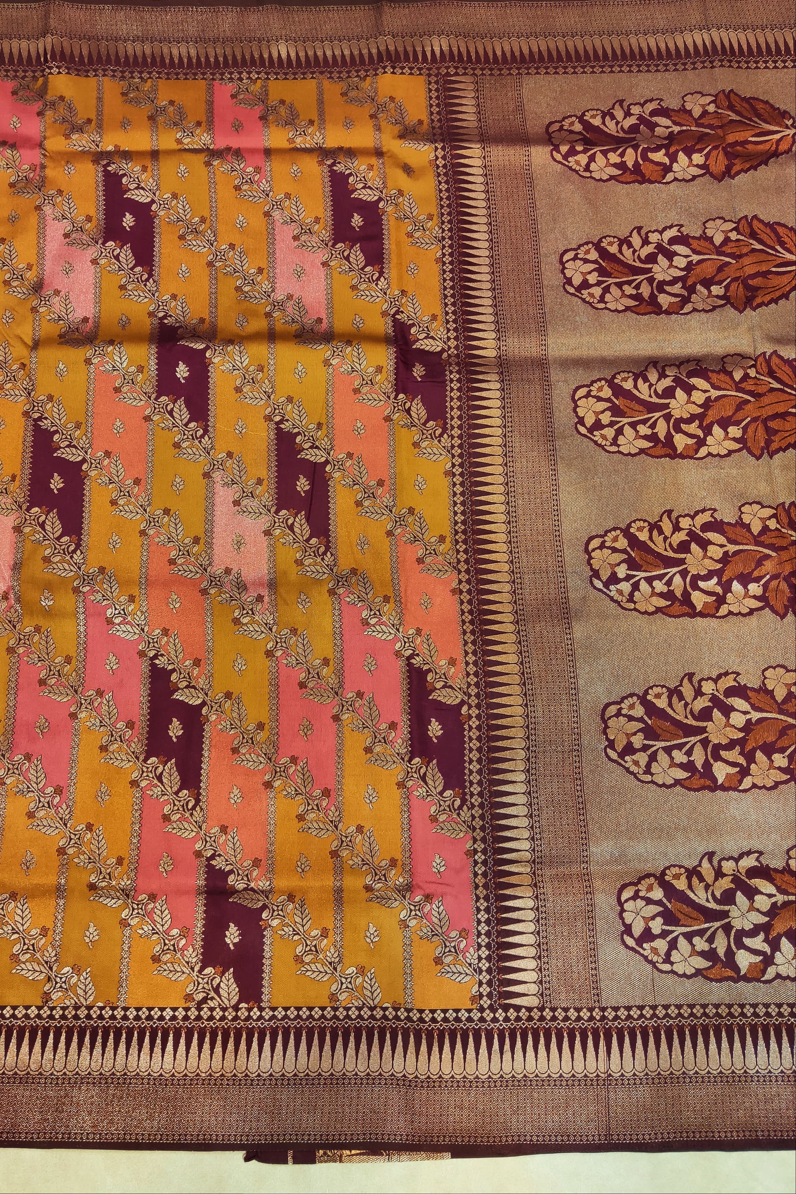 Traditional saree with a patterned design on a plain background