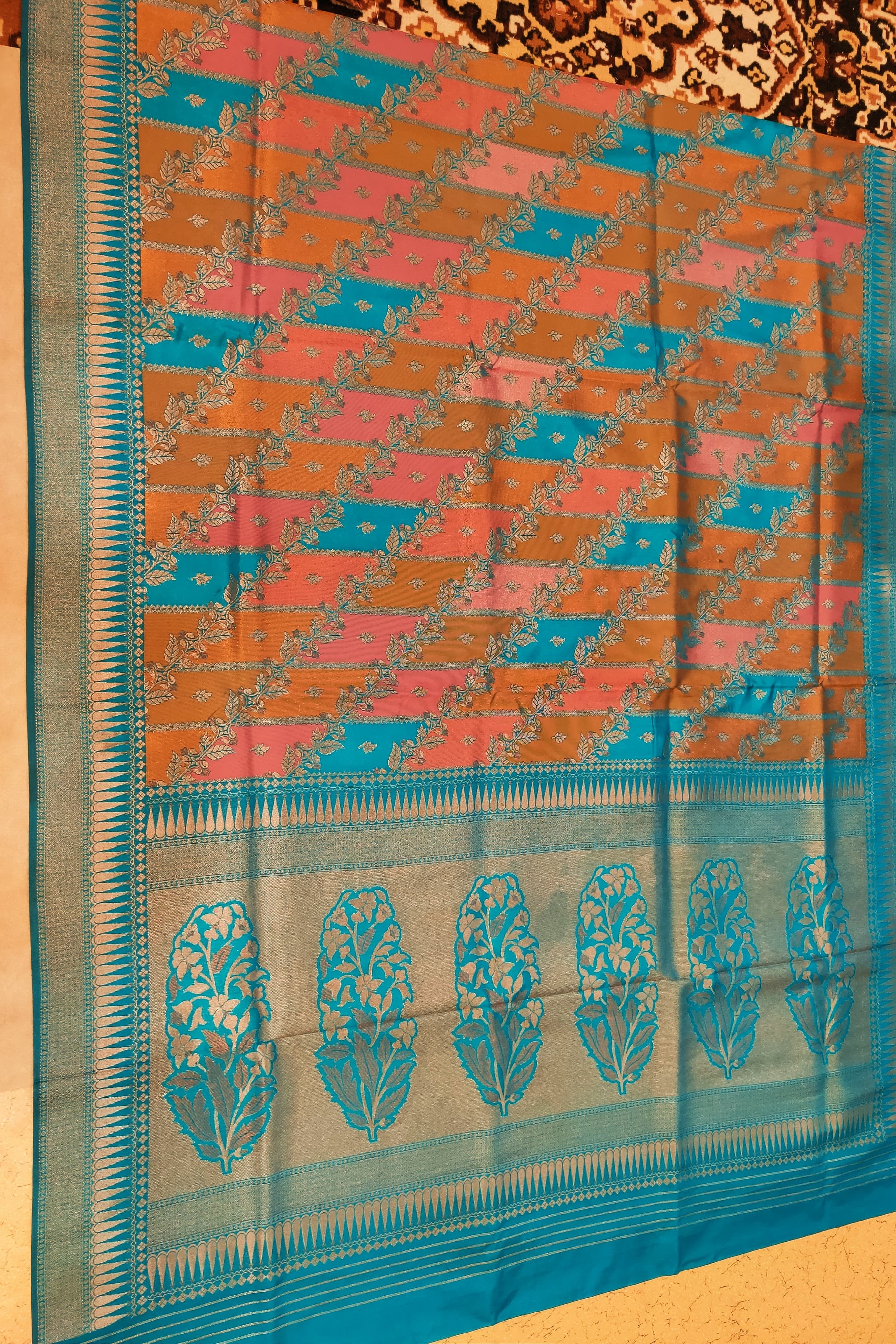 Saree with a blue and orange pattern on a yellow background