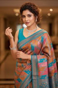 Woman wearing a colorful saree with a blurred indoor background