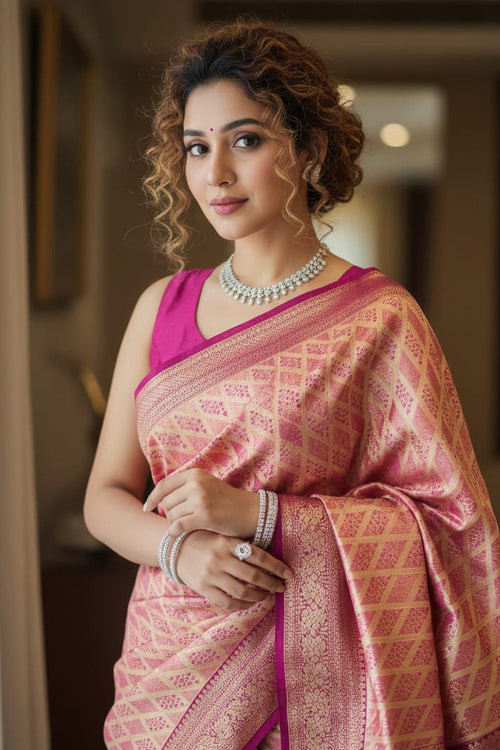 Woman in a pink saree with a blurred indoor background