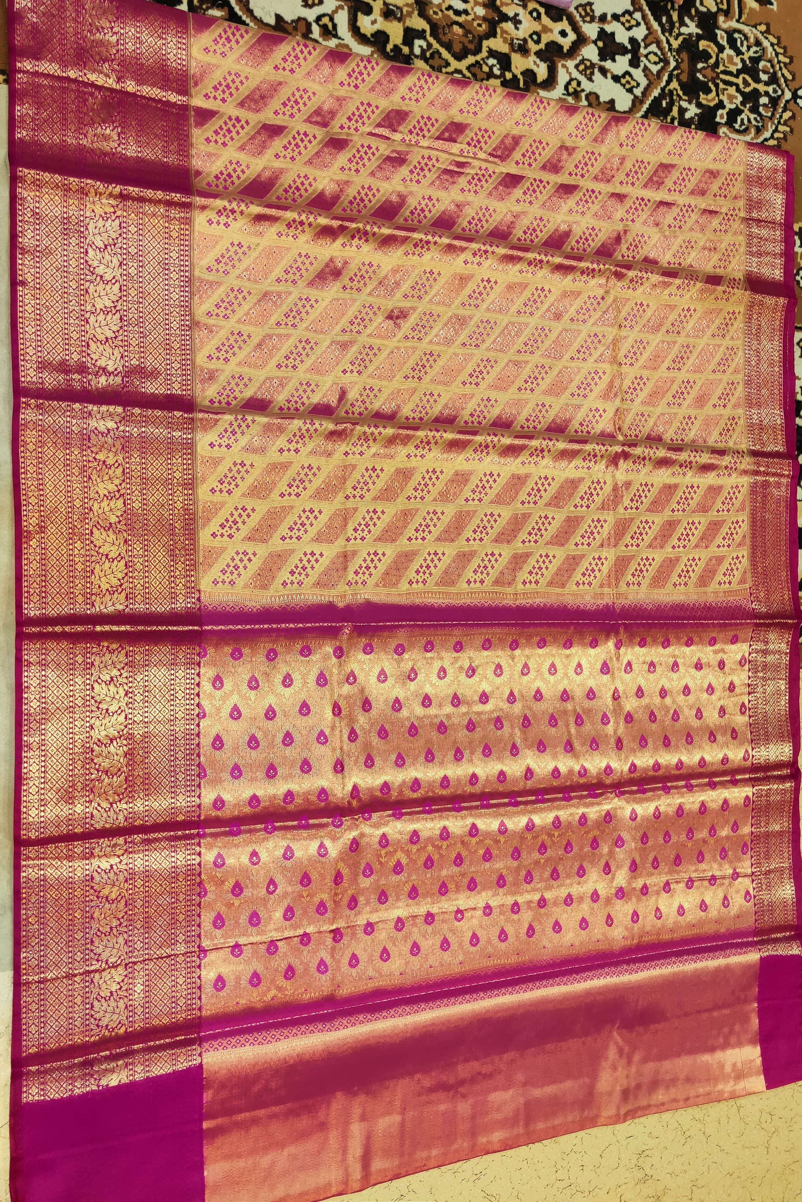 Traditional patterned fabric with a prominent border on a plain background