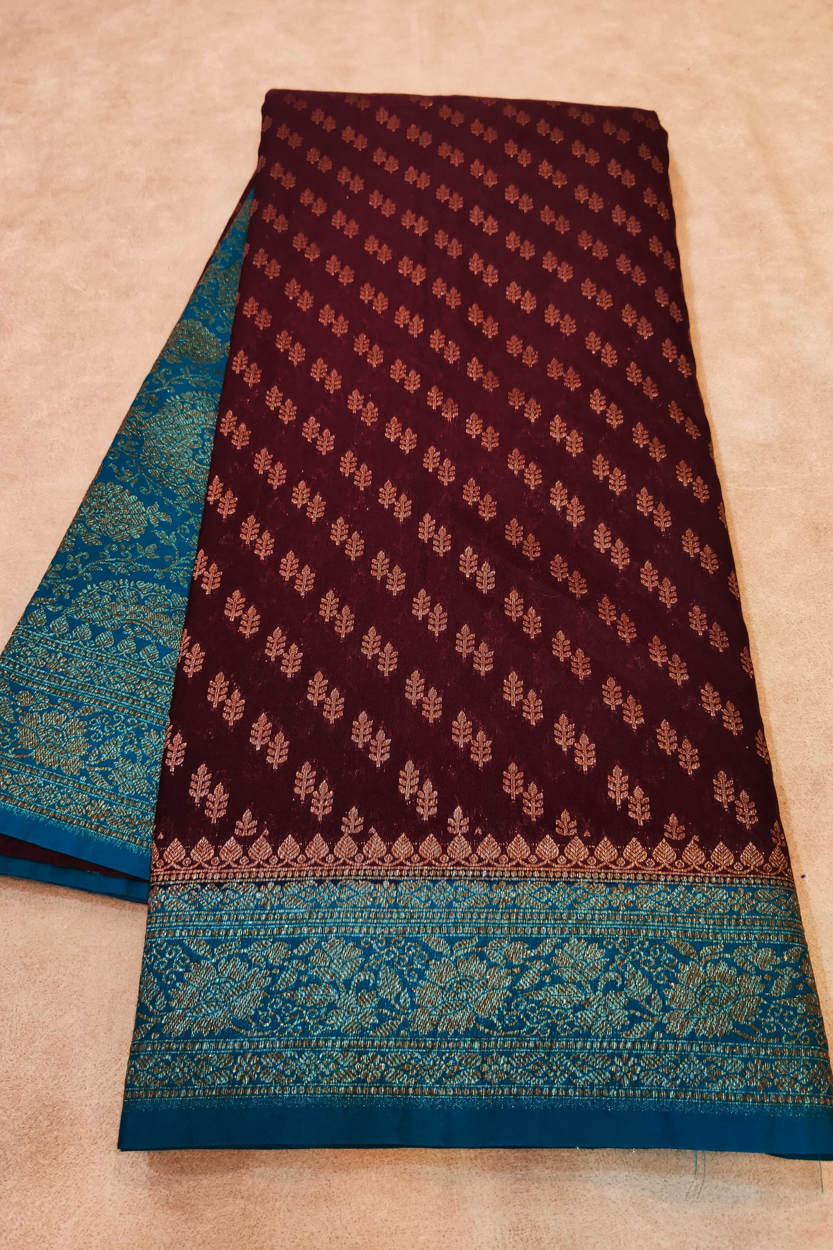 Brown and blue patterned fabric on a beige background