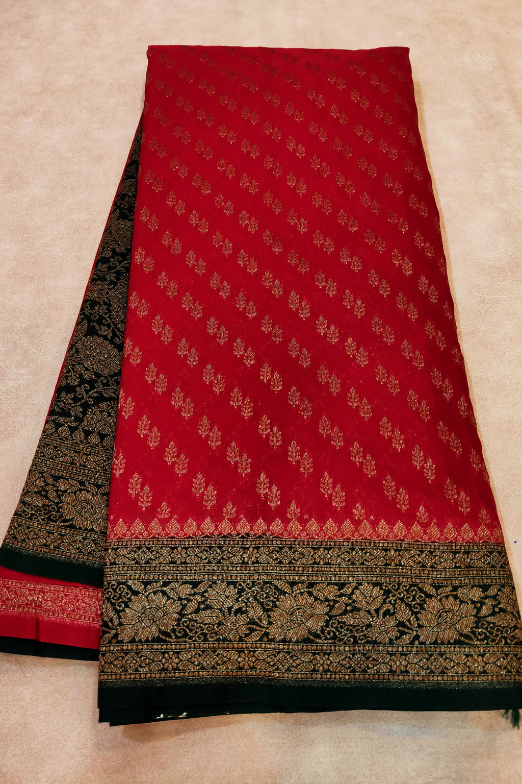 Red and black patterned fabric on a beige background