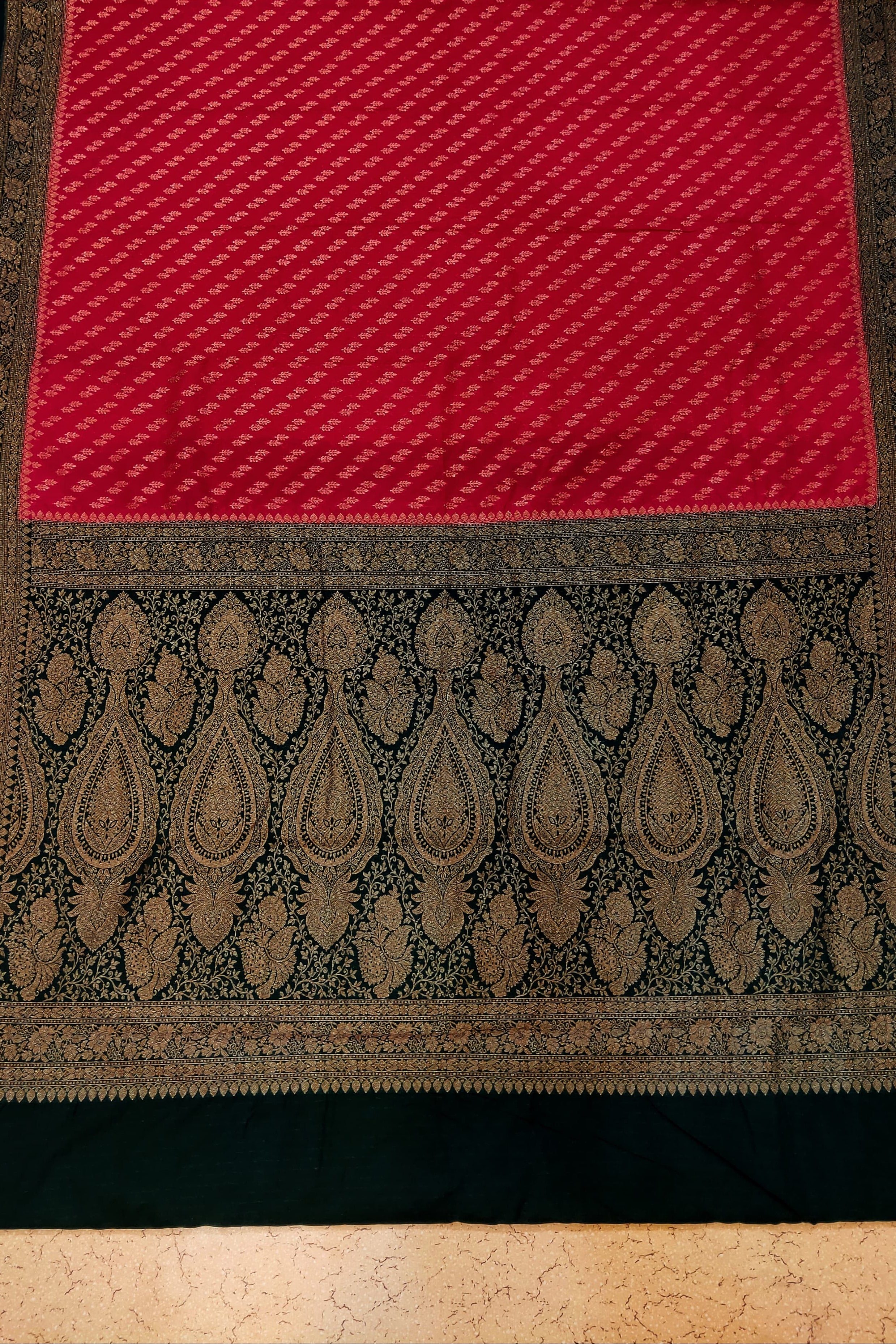 Red and black patterned fabric on a textured surface