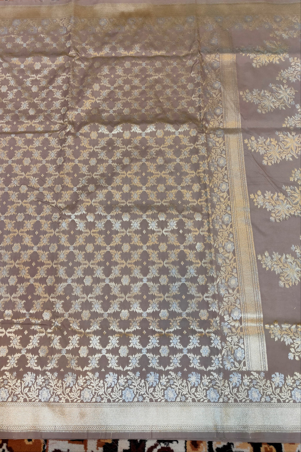 Brown fabric with floral patterns on a checkered floor background