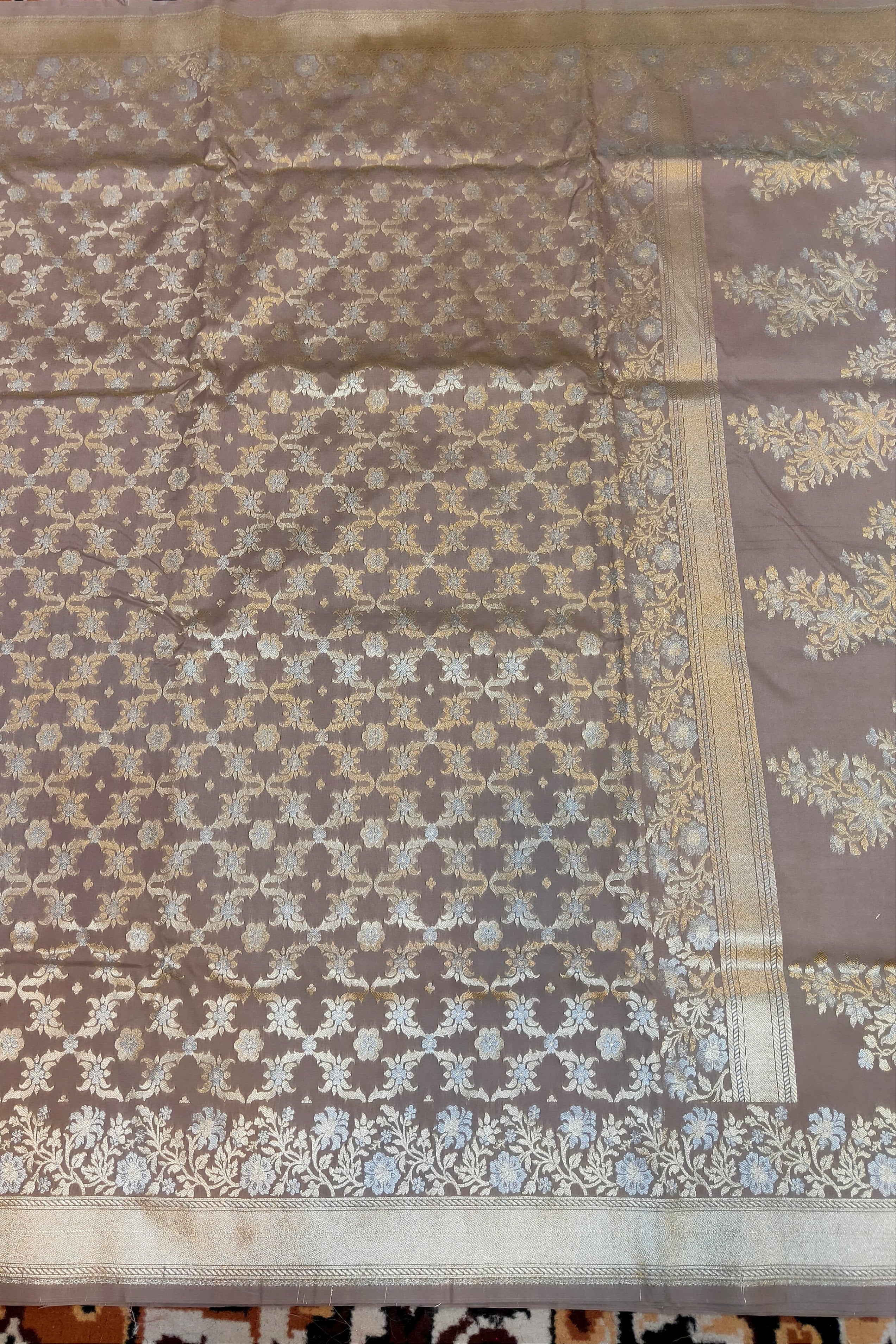 Brown fabric with floral patterns on a checkered floor background