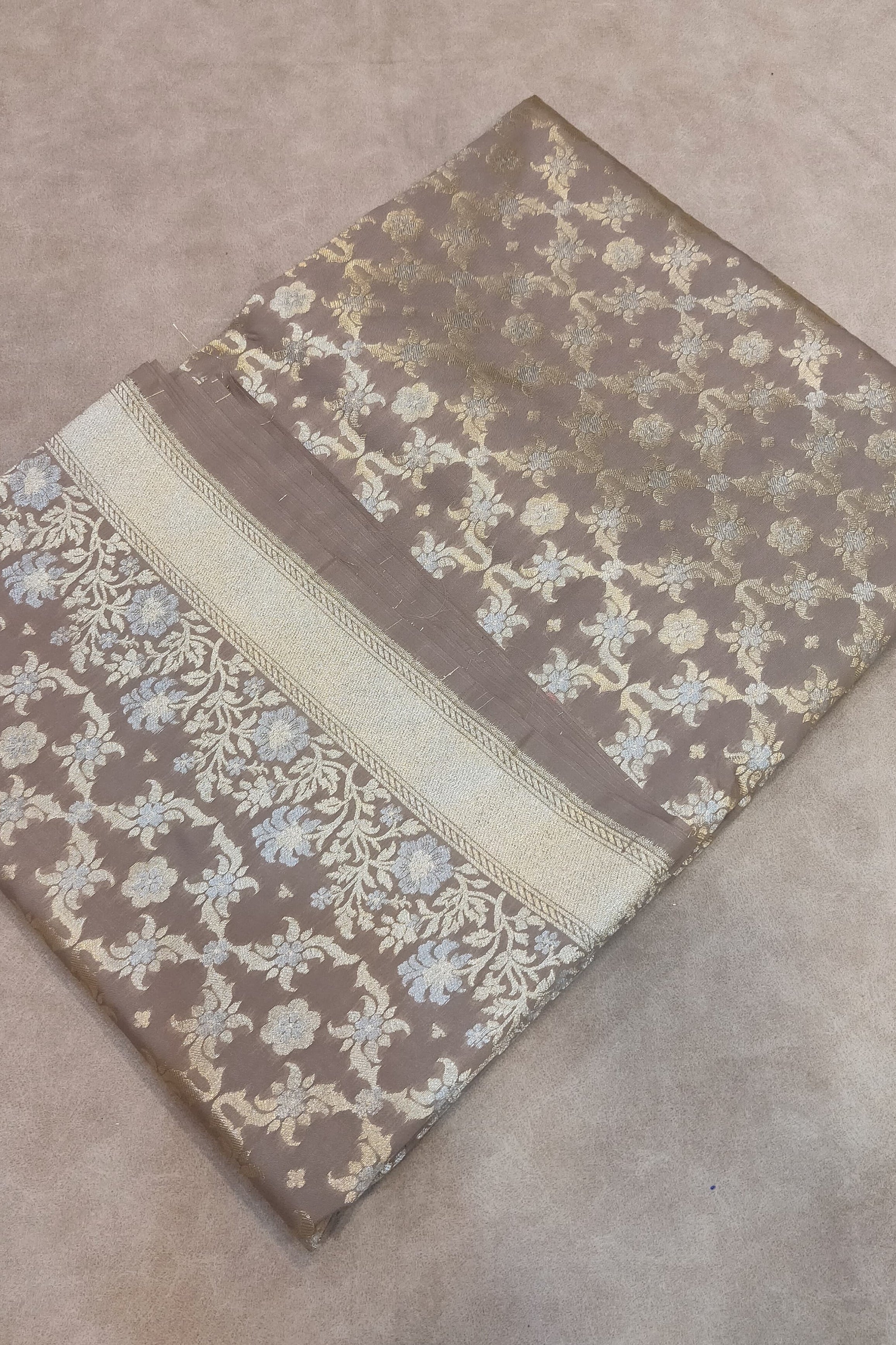 Decorative fabric with floral patterns on a beige surface
