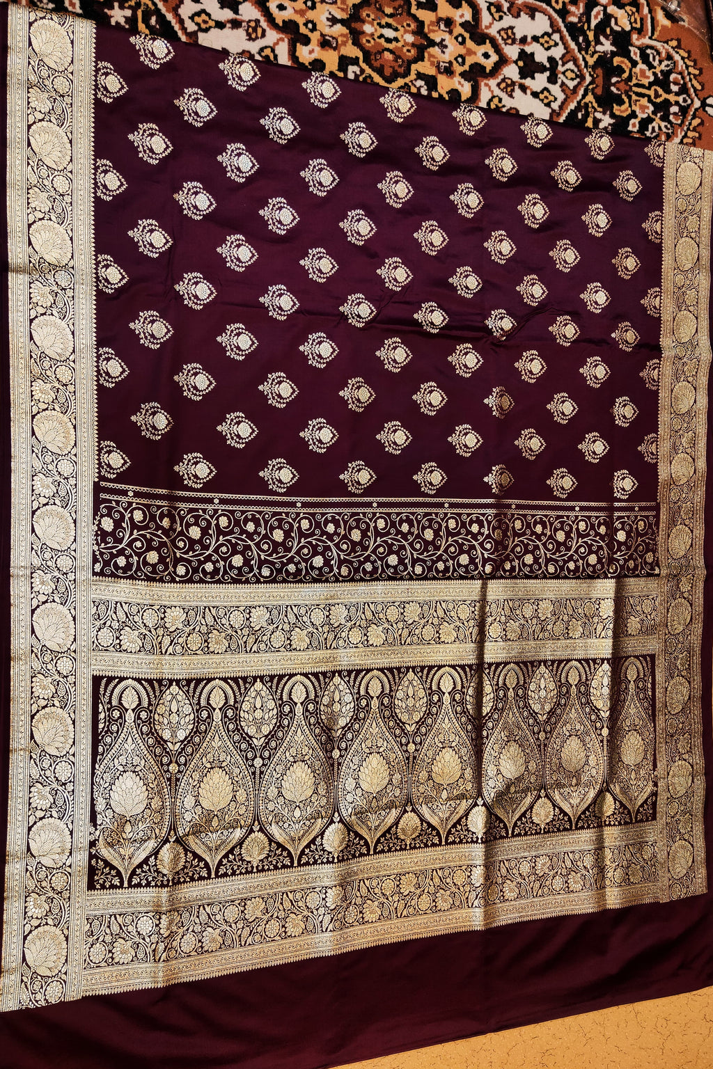 Decorative purple fabric with intricate white patterns on a wooden surface