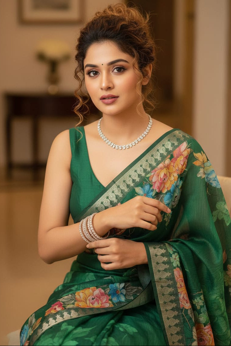 Woman in a green saree with floral patterns indoors