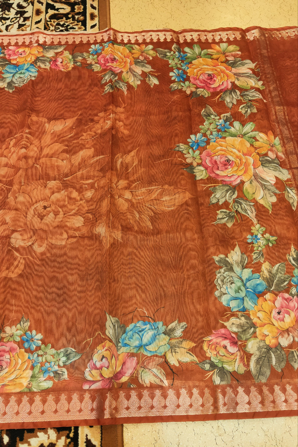 Textile with floral patterns on a brown background