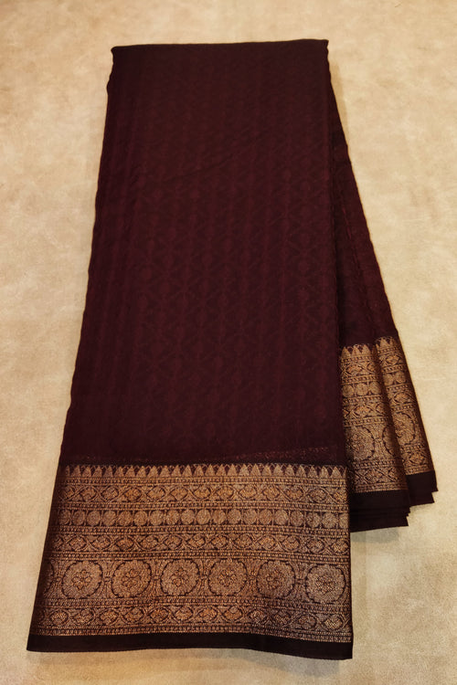 Brown fabric with intricate patterns on a beige background