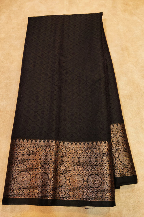 Black fabric with intricate patterns on a beige background