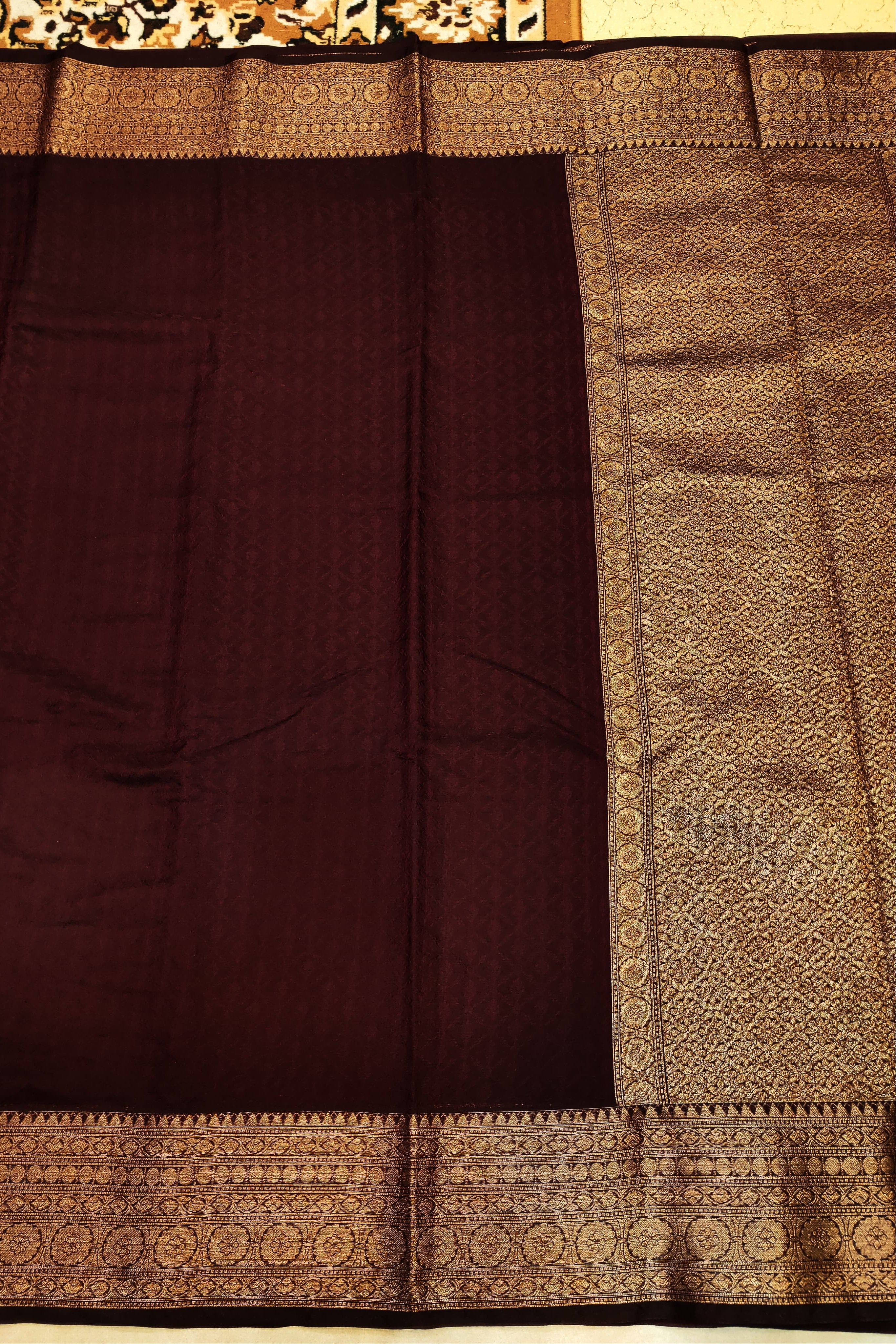 Brown saree with intricate gold border