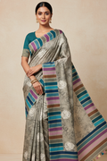 Woman wearing a traditional saree with a striped pattern on a beige background