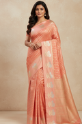 Woman wearing a peach saree with a beige background