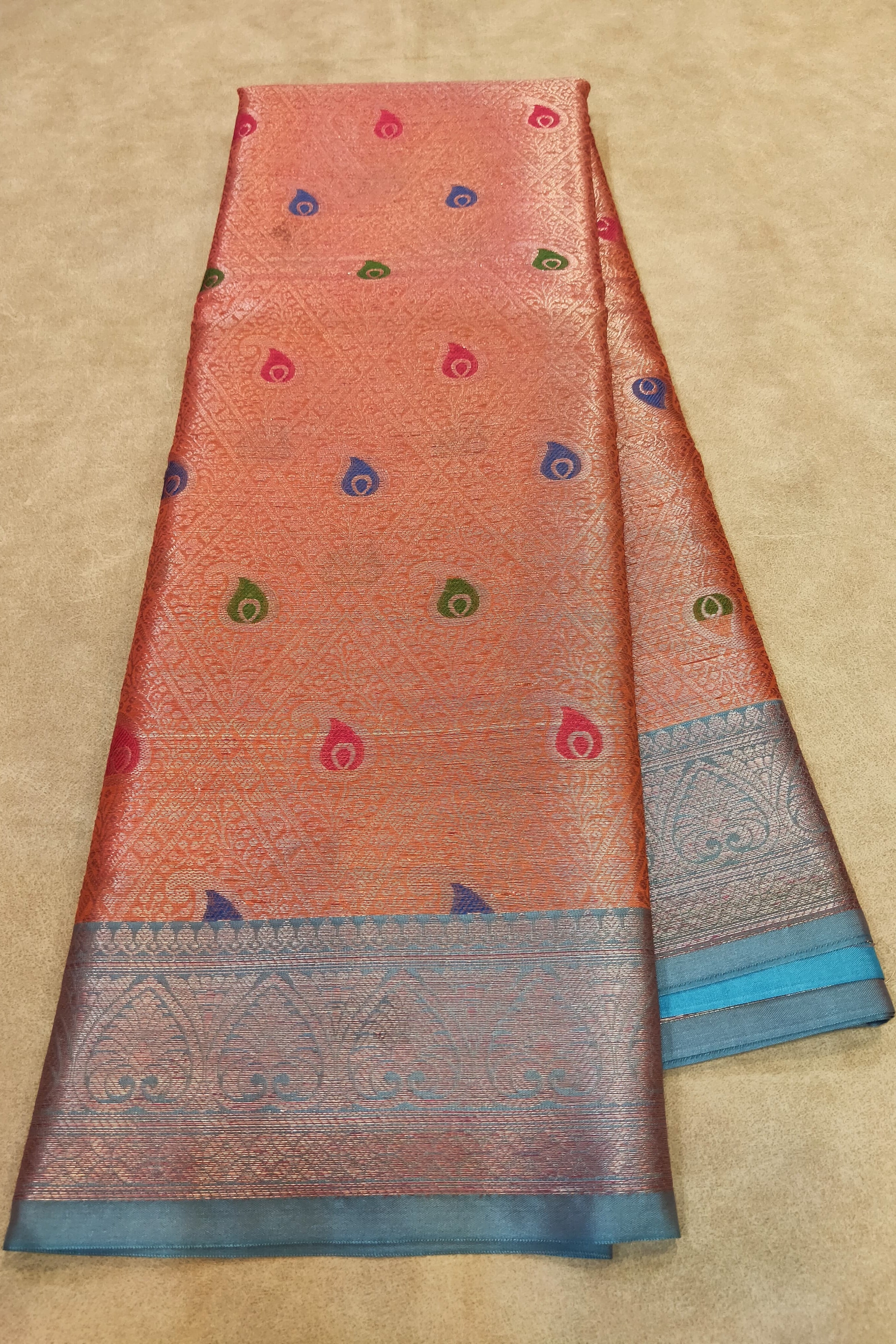 Traditional saree with a patterned border on a beige background