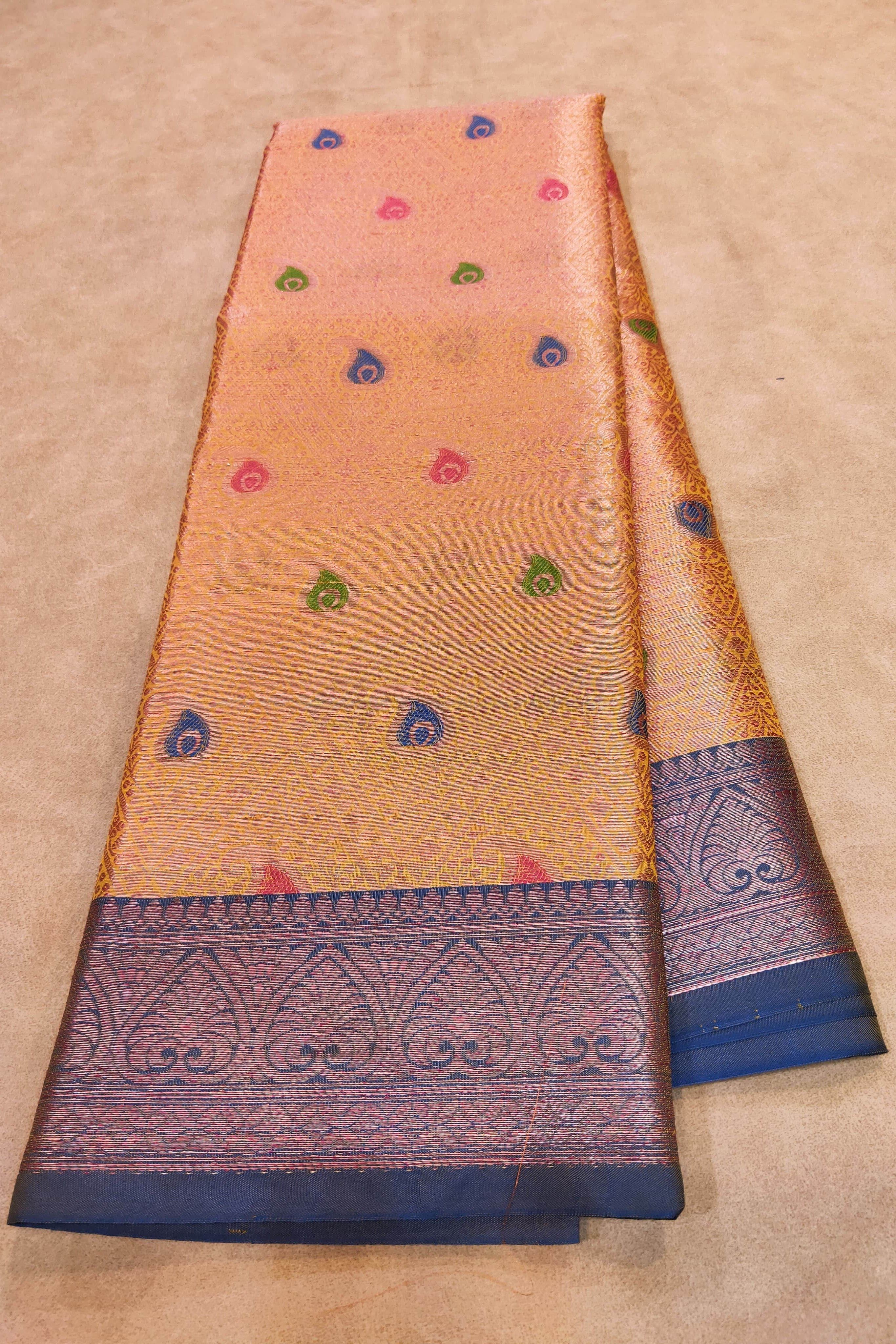 Traditional saree with a patterned border on a beige background