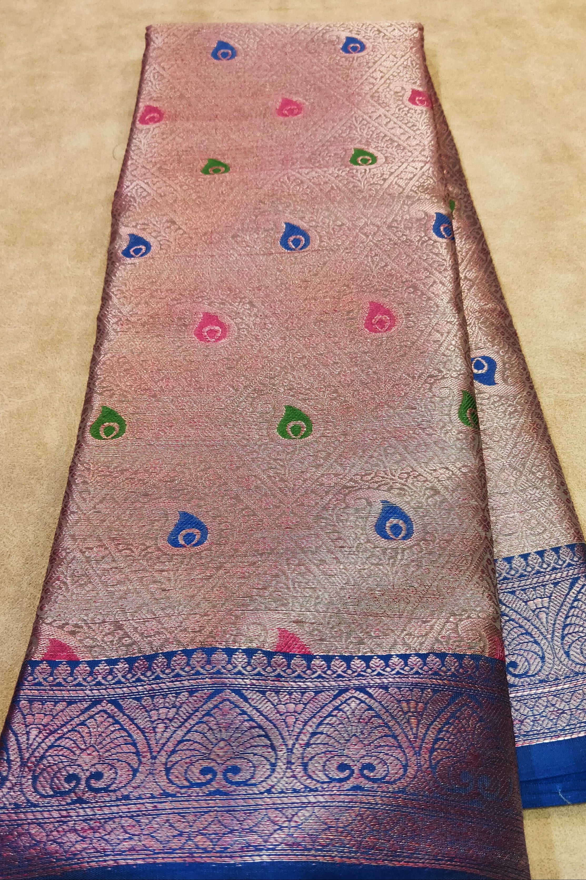 Folded fabric with decorative patterns on a beige surface