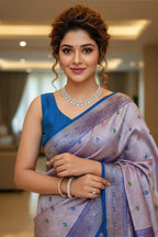 Woman in a blue and pink saree with jewelry indoors