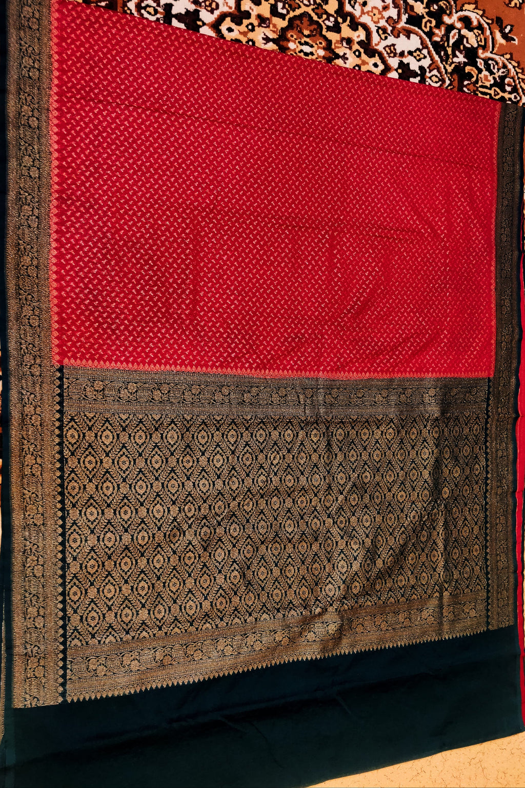 Red and black patterned fabric on a wooden surface
