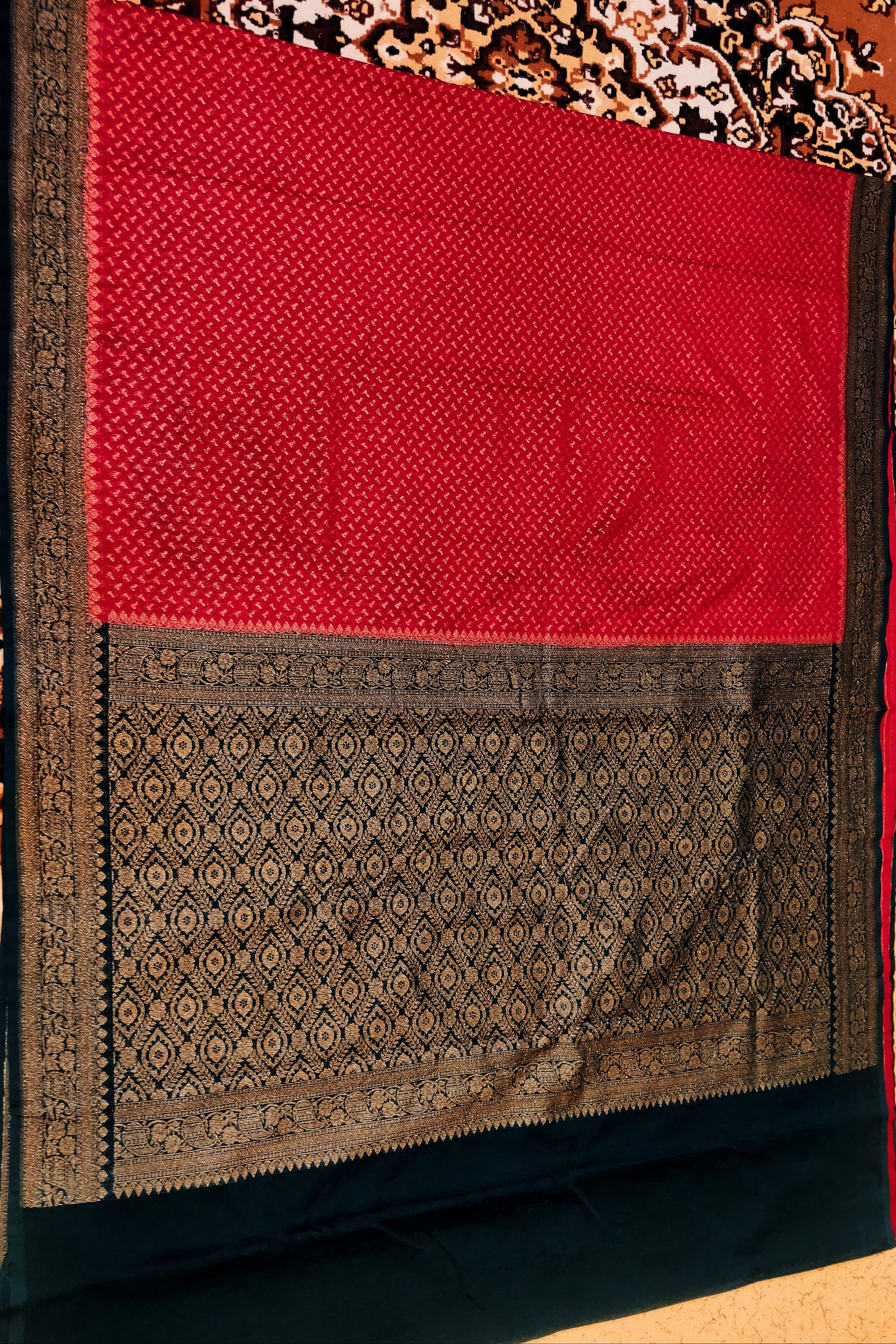Red and black patterned fabric on a wooden surface