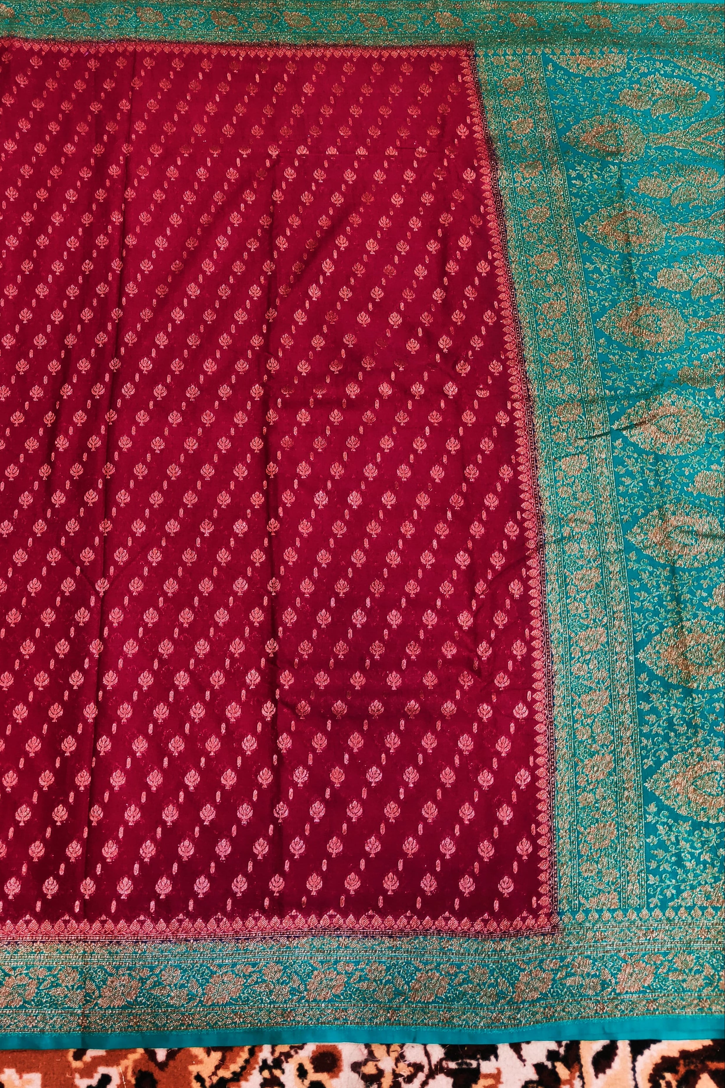 Red fabric with a blue border on a patterned background