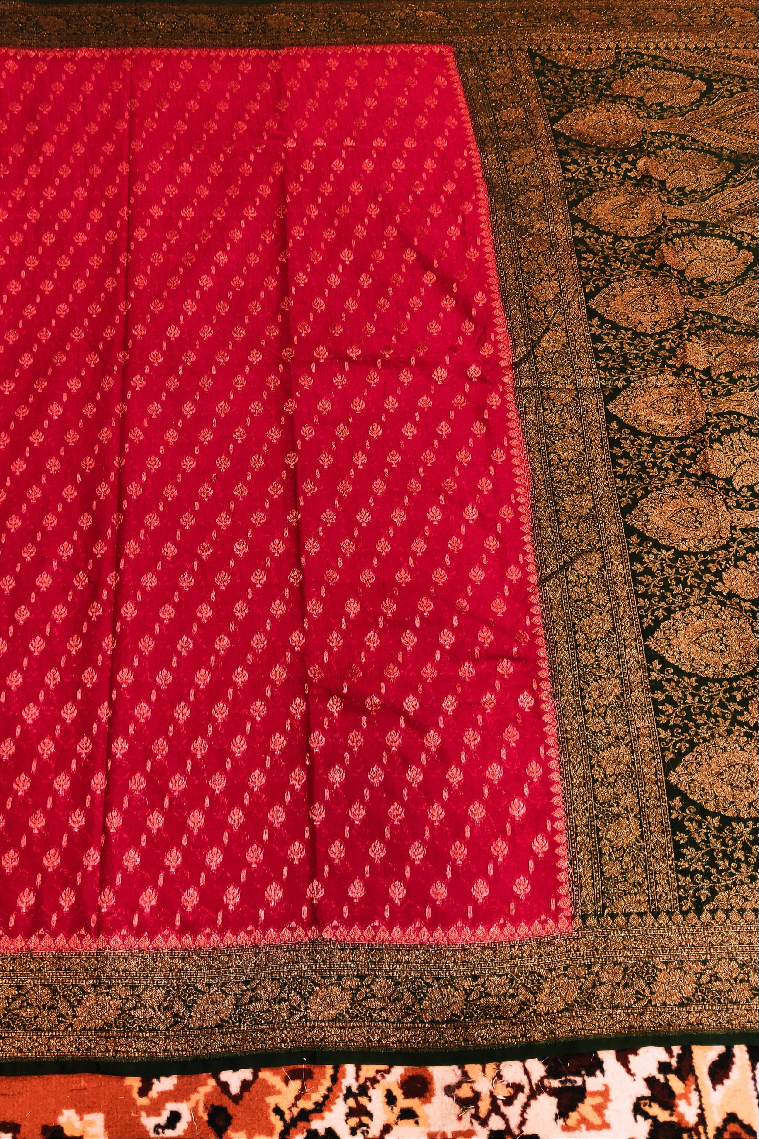 Red fabric with a black border on a patterned background