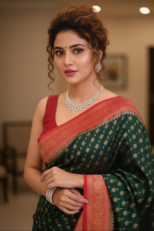 Woman wearing a green saree with red border indoors