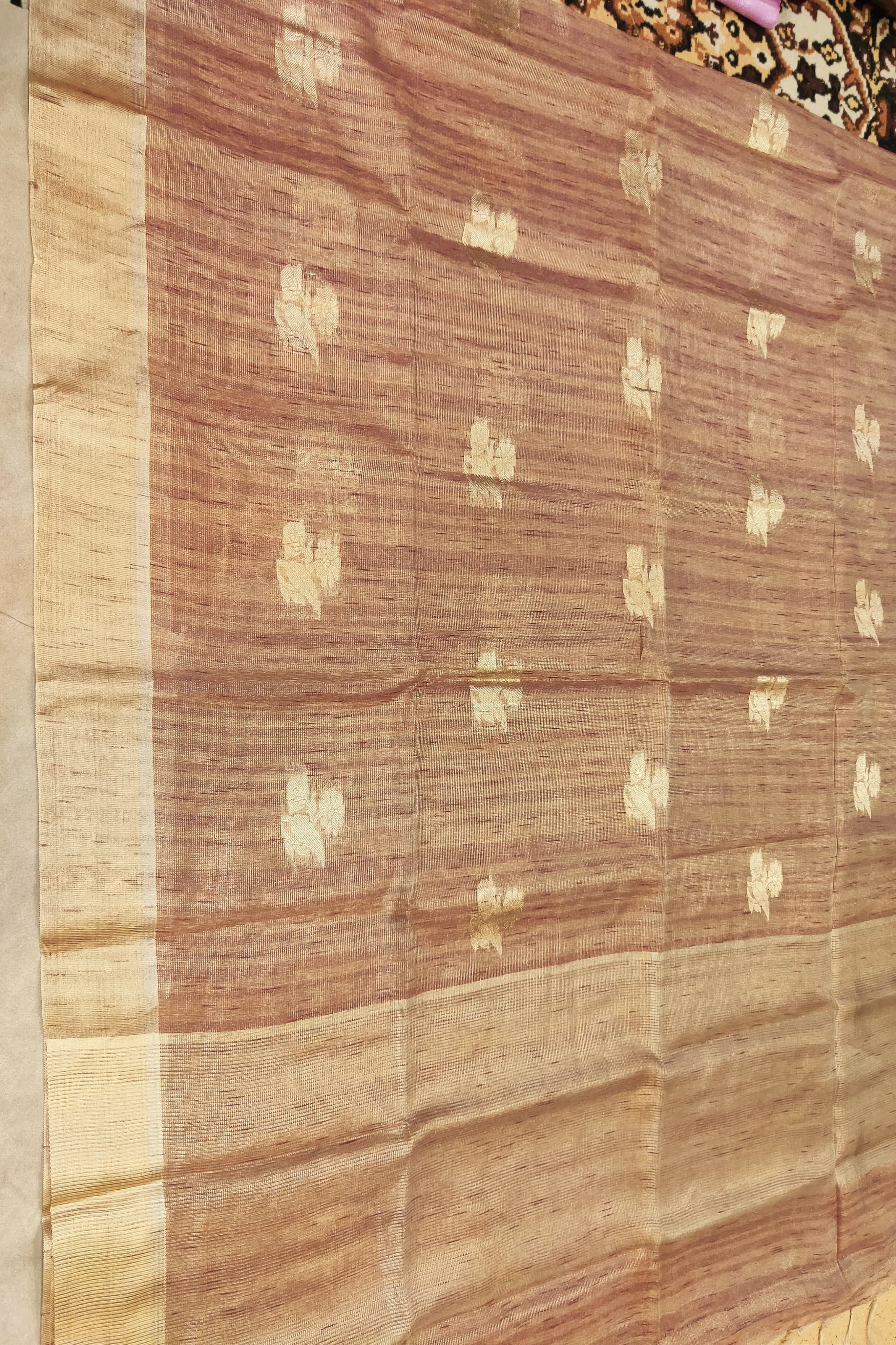 Brown and beige patterned fabric with a focus on texture and color.