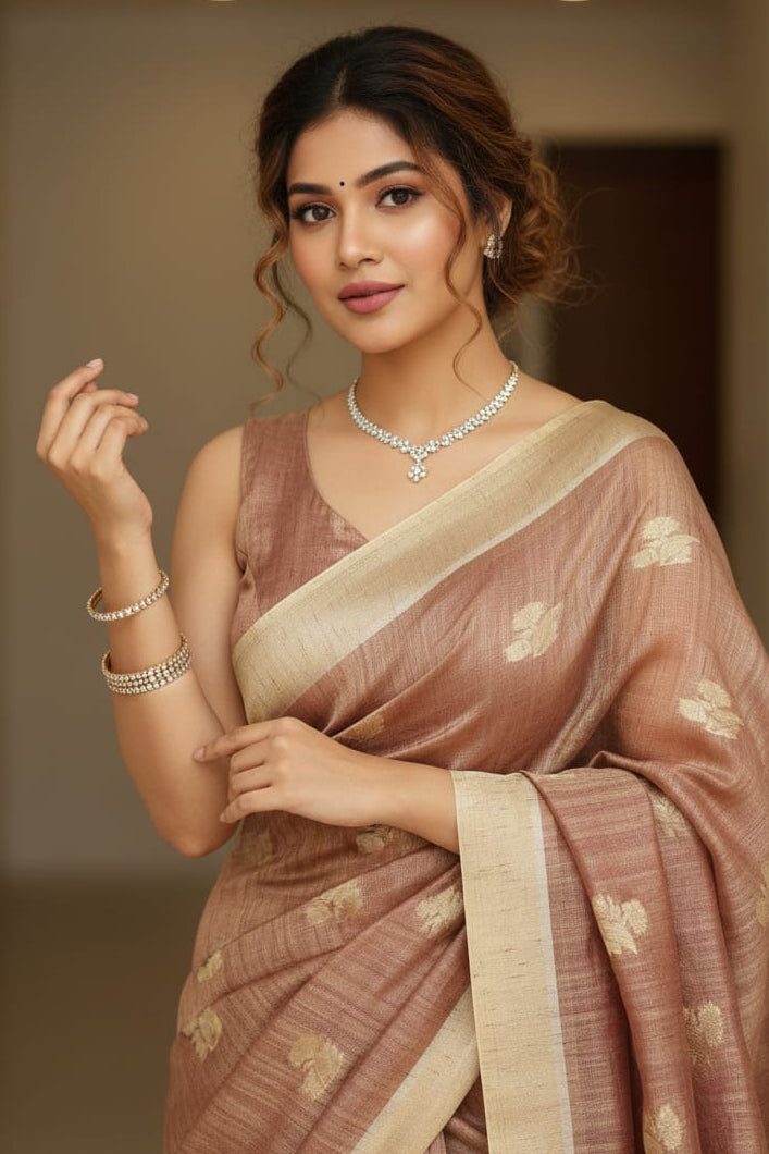Woman in a traditional saree with a neutral background